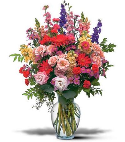 Colorful seasonal flowers in a simple glass vase